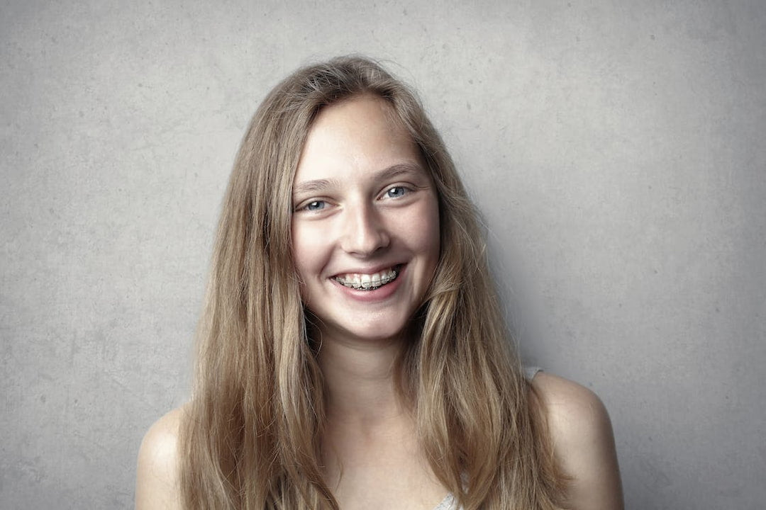a girl with braces smiling