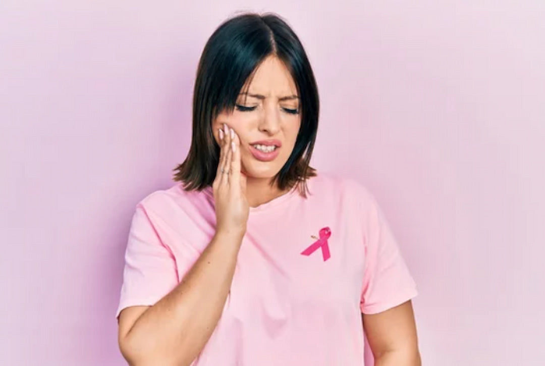 woman in pink shirt having issue with her mouth